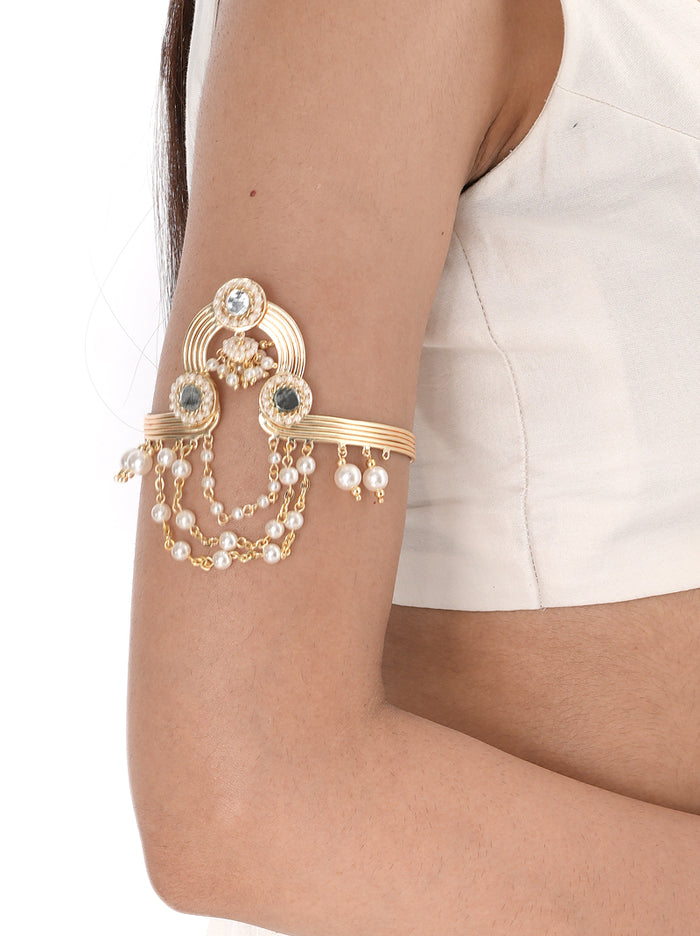 Shivika Statement Mirror Bajuband handcrafted with mirror accents, layered faux pearl chains, intricate glass bead detailing, and a Gold Tone Finish, creating an elegant bridal armlet perfect for Haldi, Mehndi, Sangeet, weddings, receptions, destination weddings, and festive celebrations.