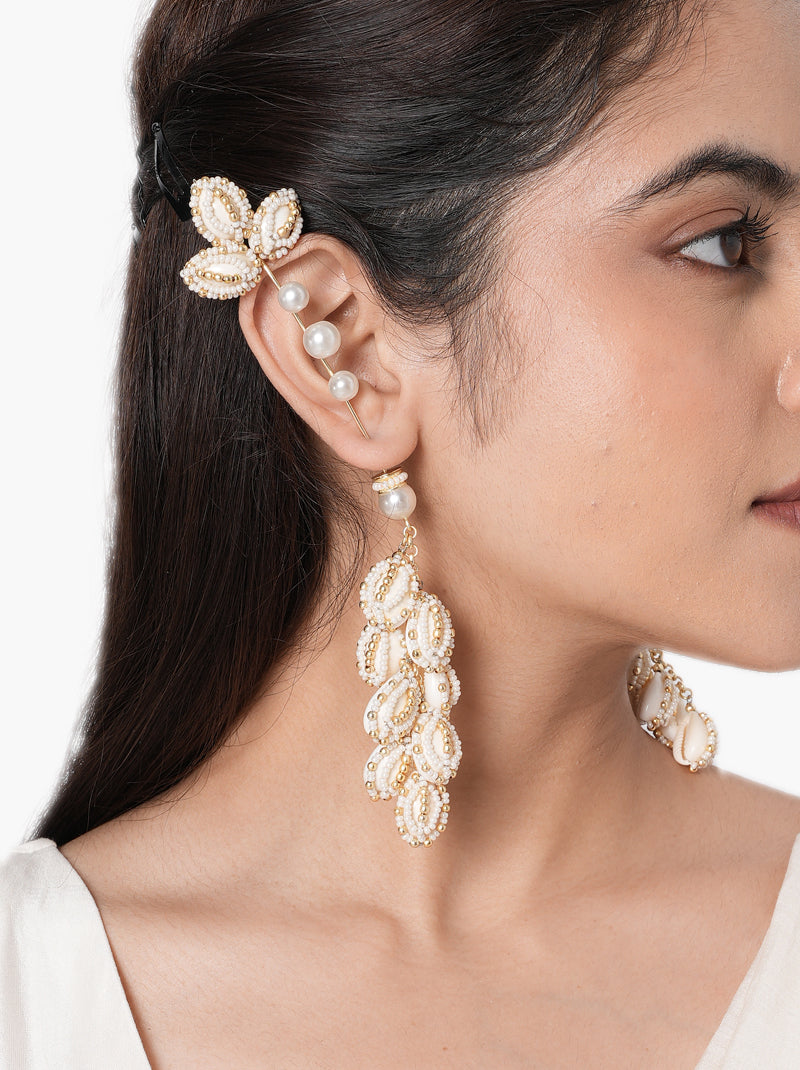 Siddhi Floral Shell Earrings handcrafted with natural shell petals, faux pearls, intricate glass bead embroidery, and a Gold Tone Finish, perfect for Haldi, Mehndi, destination weddings, festive celebrations, beach weddings, and elegant ethnic styling.