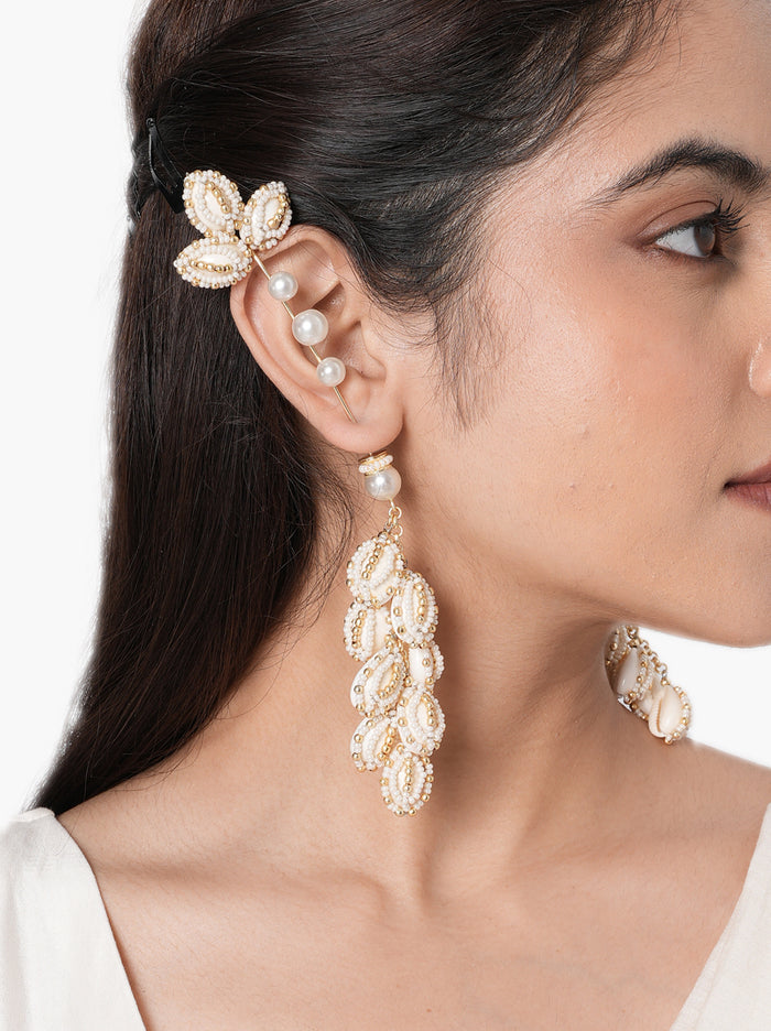 Siddhi Floral Shell Earrings handcrafted with natural shell petals, faux pearls, intricate glass bead embroidery, and a Gold Tone Finish, perfect for Haldi, Mehndi, destination weddings, festive celebrations, beach weddings, and elegant ethnic styling.