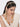 Siya Shell Tassel Hairband handcrafted with natural cowrie shells, faux pearls, glass bead detailing, cascading thread tassels, and a Gold Tone Finish, perfect for Haldi, Mehndi, destination weddings, festive celebrations, beach weddings, and elegant bridal hairstyles.
