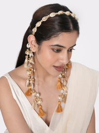 Siya Shell Tassel Hairband handcrafted with natural cowrie shells, faux pearls, glass bead detailing, cascading thread tassels, and a Gold Tone Finish, perfect for Haldi, Mehndi, destination weddings, festive celebrations, beach weddings, and elegant bridal hairstyles.