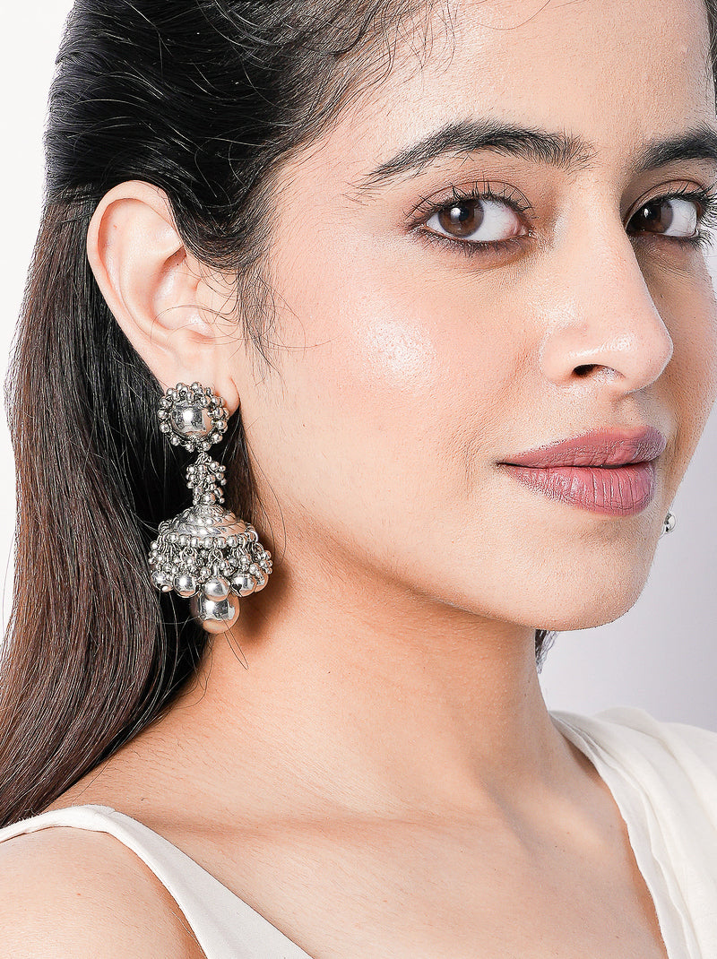 Sutradhar handcrafted statement earrings featuring intricate engraved detailing and a silver tone finish, ideal for weddings, festive celebrations, and contemporary ethnic styling.