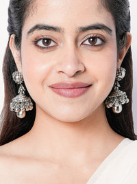 Sutradhar handcrafted statement earrings featuring intricate engraved detailing and a silver tone finish, ideal for weddings, festive celebrations, and contemporary ethnic styling.