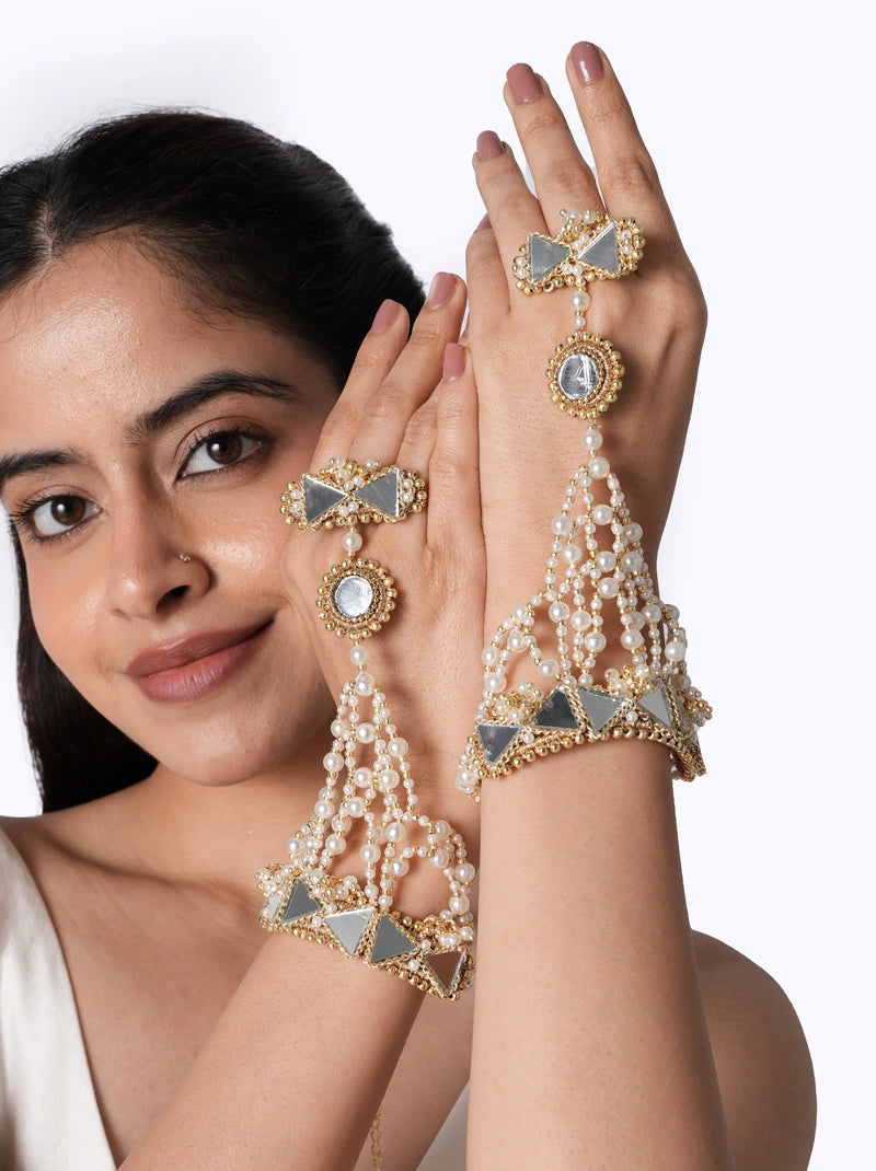 Tia Modern Bridal Haathphool handcrafted with geometric mirror accents, cascading faux pearl strands, glass bead detailing, and brass metal in a Gold Tone Finish, perfect for weddings, engagements, mehendi, haldi, receptions, and festive celebrations.