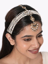 Tvesa Multi Strand Maathapatti handcrafted with layered faux pearl strands, mirror floral centerpiece, crescent pendant with pearl drops, intricate glass bead detailing, and a Gold Tone Finish, perfect for Haldi, Mehndi, Sangeet, weddings, receptions, destination weddings, and elegant bridal hairstyles.