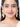 Model wearing Radha Cowrie Shell Earrings featuring natural cowrie shell drops, faux pearls, glass beadwork and handcrafted gold tone detailing.