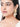Model wearing Radha Cowrie Shell Earrings featuring natural cowrie shell drops, faux pearls, glass beadwork and handcrafted gold tone detailing.