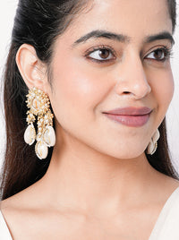 Handcrafted cowrie shell and pearl statement earrings in ivory and gold tones for haldi, mehendi, destination weddings and festive occasions.