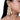 Vama Beaded Pearl Earrings featuring intricate gold-tone beadwork, layered pearl motifs and cascading teardrop detailing, styled on a woman.