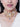 Wania Crystal Pearl Choker handcrafted with pear-cut crystals, baguette stones, intricate pearl embroidery, burgundy bead accents and a luxurious gold tone finish for bridal and festive occasions.