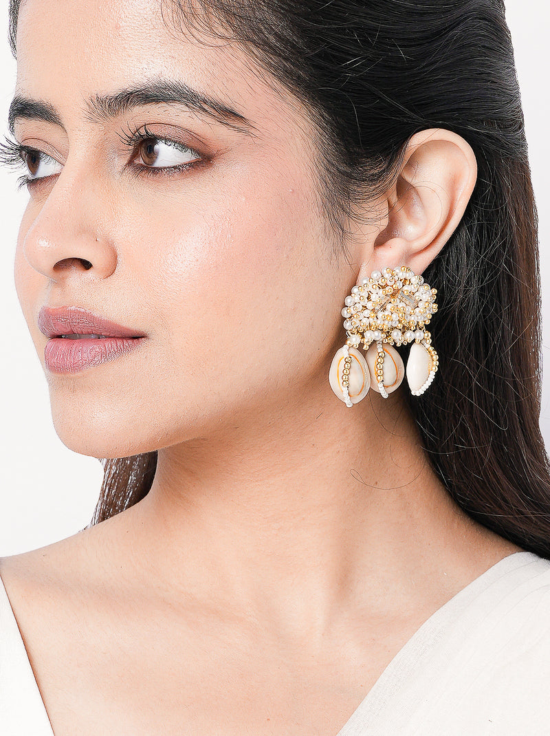Yug Embroidered Shell Earrings featuring embroidered beadwork, cowrie shell drops, faux pearls and a gold tone finish for bridal and festive wear.