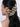 Model wearing Binti Shell Bridal Earchain featuring handcrafted natural shells, faux pearls and layered chain detailing attached from hair to ear in a Gold Tone Finish.
