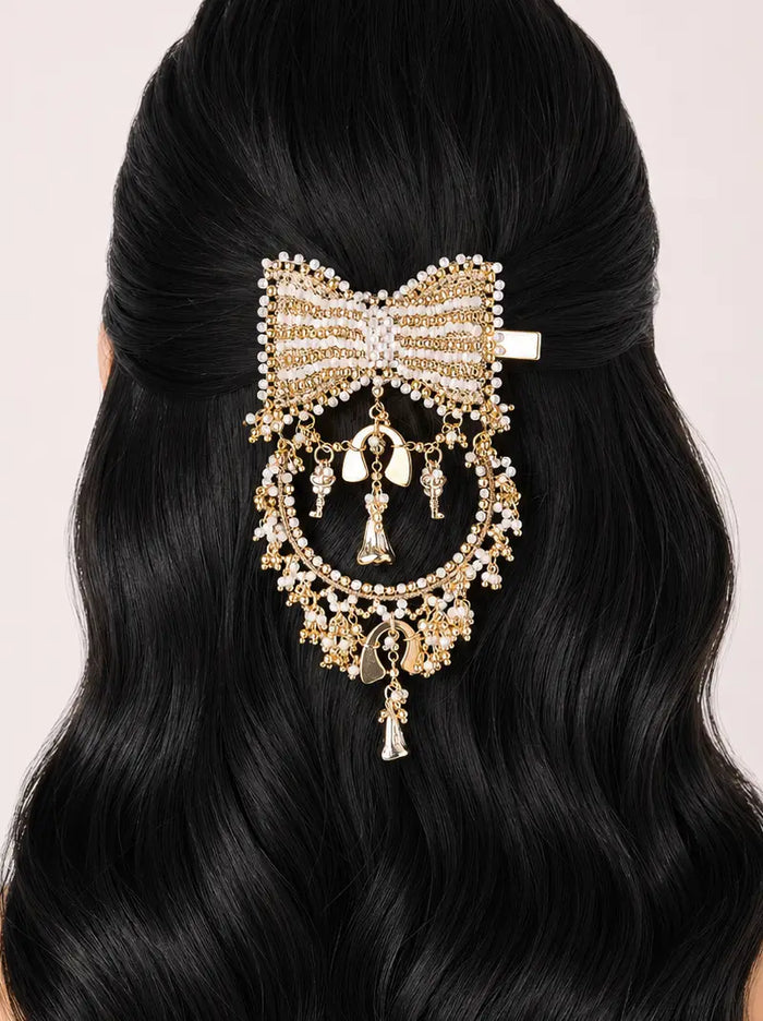 Divyansh Bow Hair Accessory featuring a handcrafted bow design with faux pearls, intricate beadwork, cascading charms and a gold tone finish, perfect for bridal hairstyles, weddings and festive occasions.