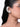 Model wearing Estelle Crystal Halo Earcuff featuring baguette, pear and round crystal stones in a Silver Tone Finish with a curved ear-hugging design.