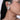 Model wearing Genna Crystal Bloom Earcuff featuring a floral crystal motif connected to an upper ear cuff in a Silver Tone Finish.
