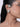 Model wearing Genna Crystal Bloom Earcuff featuring a floral crystal motif connected to an upper ear cuff in a Silver Tone Finish.