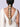 Model wearing Morska Shell Braid Accessory featuring handcrafted shell flowers, faux pearls, beadwork and cascading shell tassels in a Gold Tone Finish.