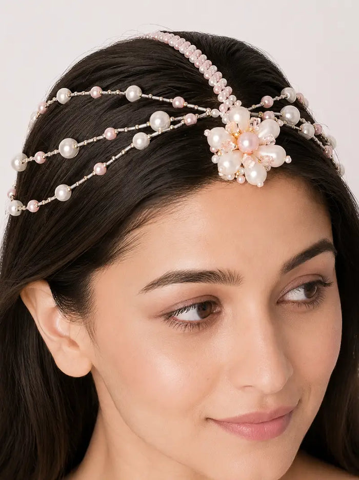 Rivaya Pearl Hair Accessory handcrafted with faux pearls, blush pearl accents, floral detailing and gold tone finish for bridal and festive hairstyles.