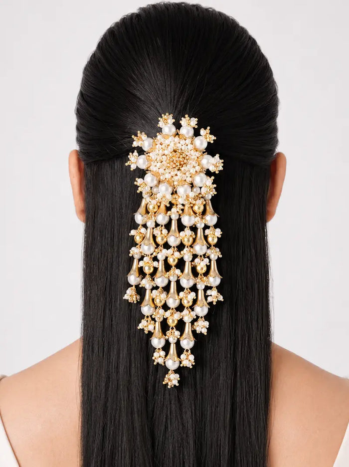 Uma Pearl Cascade Hair Clip featuring a handcrafted floral pearl design with cascading pearl drops in a gold tone finish, ideal for bridal hairstyles, weddings, festive occasions, and elegant traditional looks.